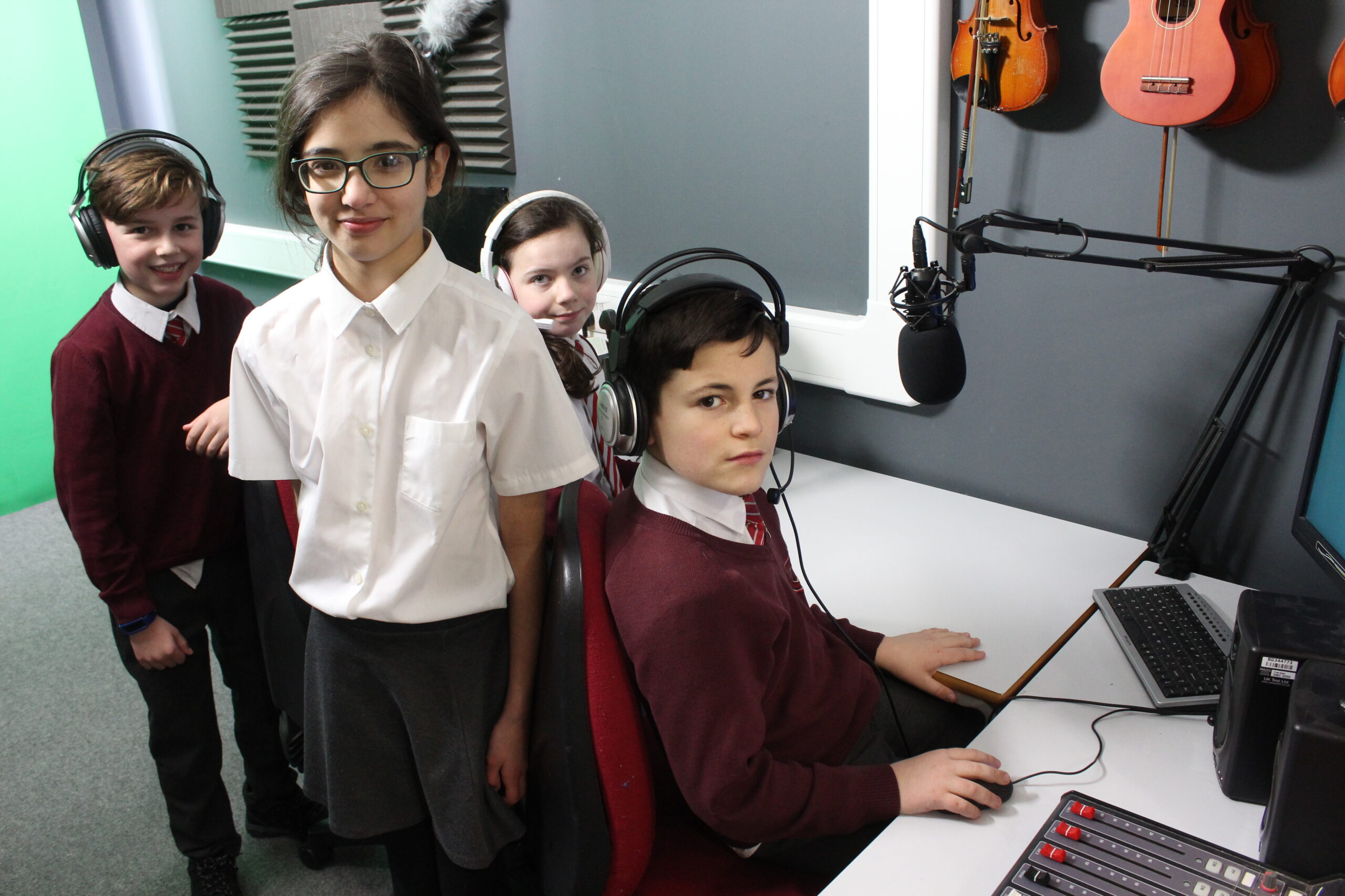 Children recording together in the school studio